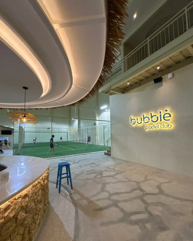 The Bubble logo wall beside the stone bar